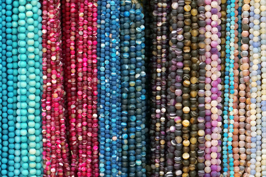 Colorful Beads Background. Background pattern of multicolored natural stone beads. String of beads in various colors. Colorful beads necklaces. Handicraft fashionable for women