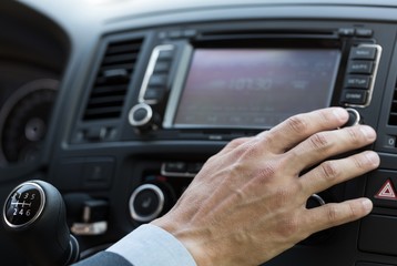 Closeup of a Businessman Using a Car Audio System