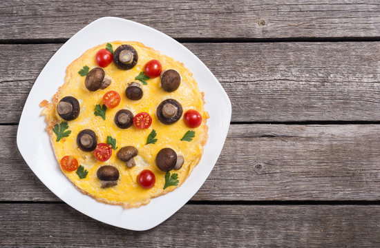 Omelette with mushroom , tomato and parsley