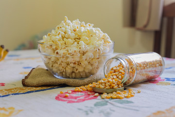 glass bowl with popcorn and corn seeds