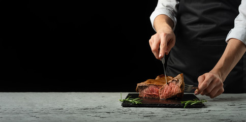 Beef steak with rosemary on a black background with open space for text or restaurant menus....