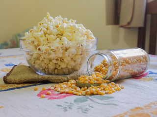 glass bowl with popcorn and corn seeds
