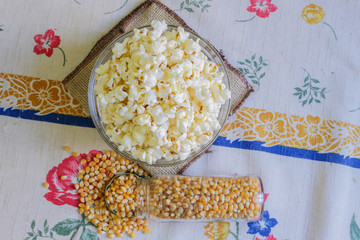 glass bowl with popcorn and corn seeds