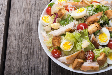 Salad ceasar with chicken , eggs and tomatoes