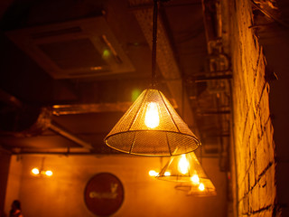 Vintage lighting lamp hang in front of cement brick wall at loft.