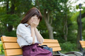 young asian woman sitting bench in park