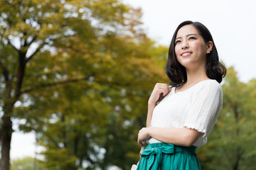 attractive asian woman relaxing in park