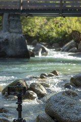 Smartphone on a tripod facing a river (vertical)