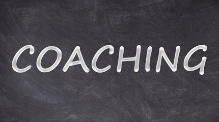 Coaching written on blackboard