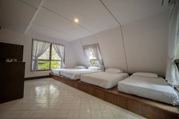 Fototapeta na wymiar interia perspective of quad hotel bedroom with four twin beds for four persons at Samed Cabana Samed island Rayong district Thailand