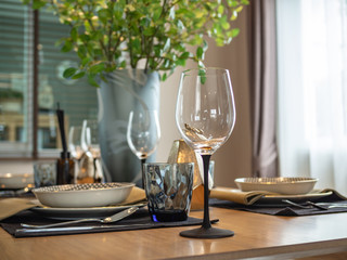 Dinner table setup with empty glass of wine
