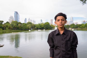 Portrait of young Indian boy relaxing at the park