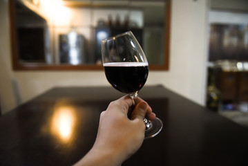 Toast using wine glass with red wine