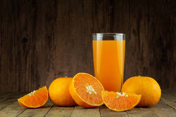Glass of fresh orange juice on vintage wood table with copy space 