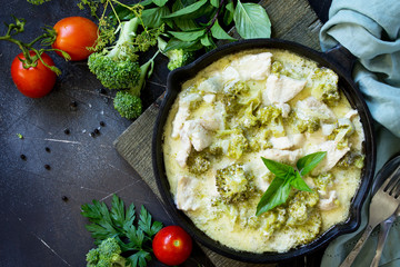 Healthy food: Chicken Stew with Broccoli and Sour Cream on a stone or slate background. Diet menu. Top view flat lay background. Copy space.