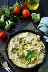 Healthy food: Chicken Stew with Broccoli and Sour Cream on a stone or slate background. Diet menu.