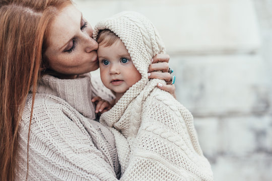 Mom And Baby Dressed In Warm Winter Knitted Clothing