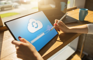 Cloud synchronization progress bar on tablet screen. Data storage and protection. Technology and...