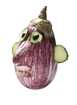 Creative face compiled from eggplant and cucumber