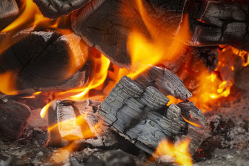 Coals in a hot fire close up.