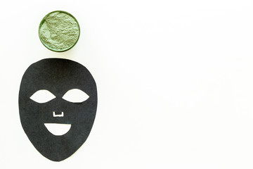 Black facial mask. Black head remover mask. Mask with clay on white background top view copy space