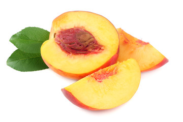 Nectarine with green leaf and slices isolated on white background.