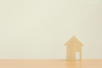 Wood house model on white background,Choosing the right real estate property, or new home in a housing development or community