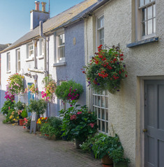 Fototapeta na wymiar Quaint row of cottages on a small street in the Pemrbrokeshire town on Tenby in South Wales