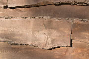 Old dirty planks on wooden wall