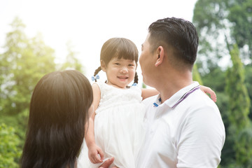 Outdoor portrait of Asian family.