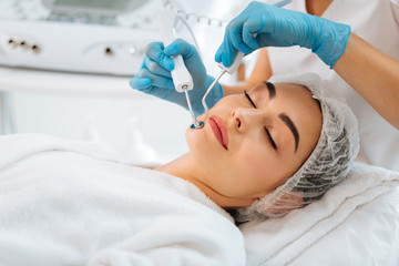 Pleasant mood. Beautiful attractive woman lying with her eyes closed while enjoying new beauty procedure