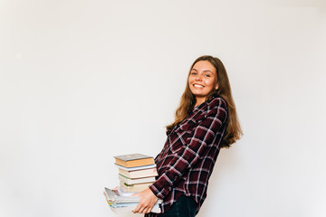 Pretty teen gild student of school or college with stack of books education