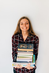Pretty teen gild student of school or college with stack of books education