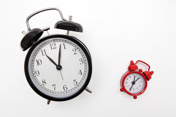 Black and red alarm clocks on a white background