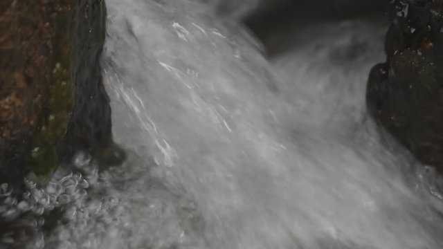 raging flow of the waterfall .
