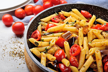 Pasta, penne with cherry tomatoes, aubergines, garlic, oregano and extra virgin olive oil.