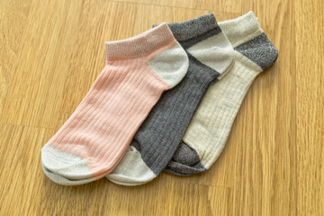 colorful socks on the wooden background.
