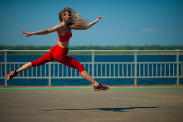 Young fitness woman running on the coast. The concept of a healthy lifestyle