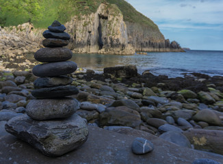 Rock Pile on a beach in South Wales with a soft background of the Church Doors