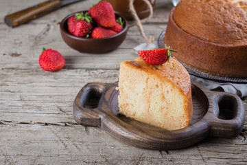 ?lassical sponge cake on wooden table background. Copy space