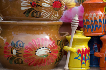 Honey pot and dipper. Traditional Romanian painted clay pots used for Easter meals. Decorations and ornaments on bowl. Beautiful kitchen decor