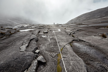 young woman hiking on the top of mount Kinabalu
