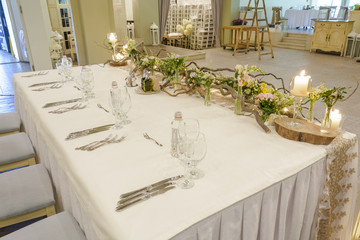 wedding table with forks, knifes and decoration.  table for the married.