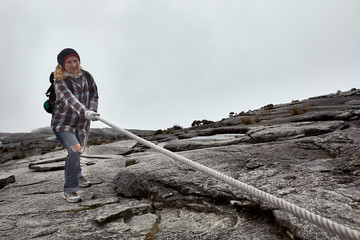 young woman hiking on the top of mount Kinabalu