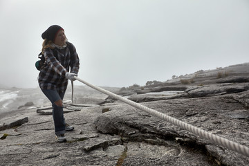 young woman hiking on the top of mount Kinabalu