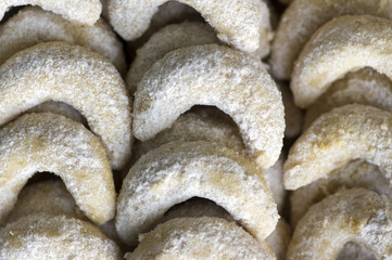 Traditional czech sweet Christmas cookies, vanilla rolls with white icing