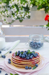 Vintage pancakes outside garden with blueberries