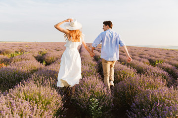 Back view pretty young couple at the lavender field
