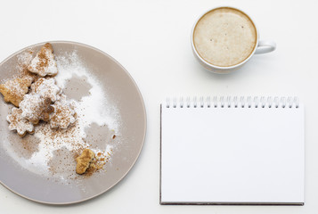 Holiday cookies and blank notepad background. Coffee Christmas mockup. Top view.