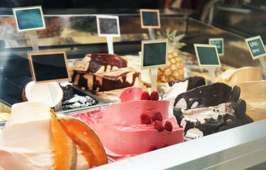 Different ice cream behind the glass in the store.
